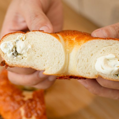 bread secret squeezing the cream out of cream cheese jalapeno bagel