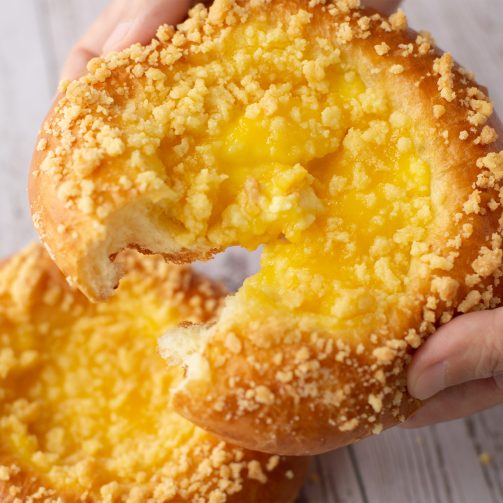 bread secret hand splitting a lemon crumble bread