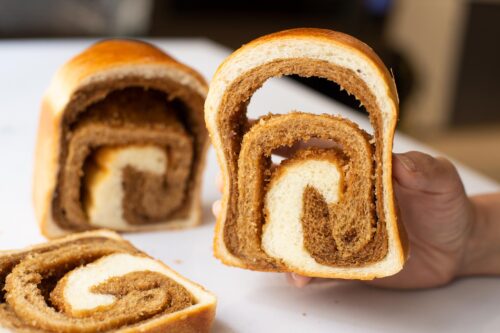 bread-secret-holding-a-slice-of-coffee-swirl-loaf bread-secret-holding-a-slice-of-coffee-swirl-loaf